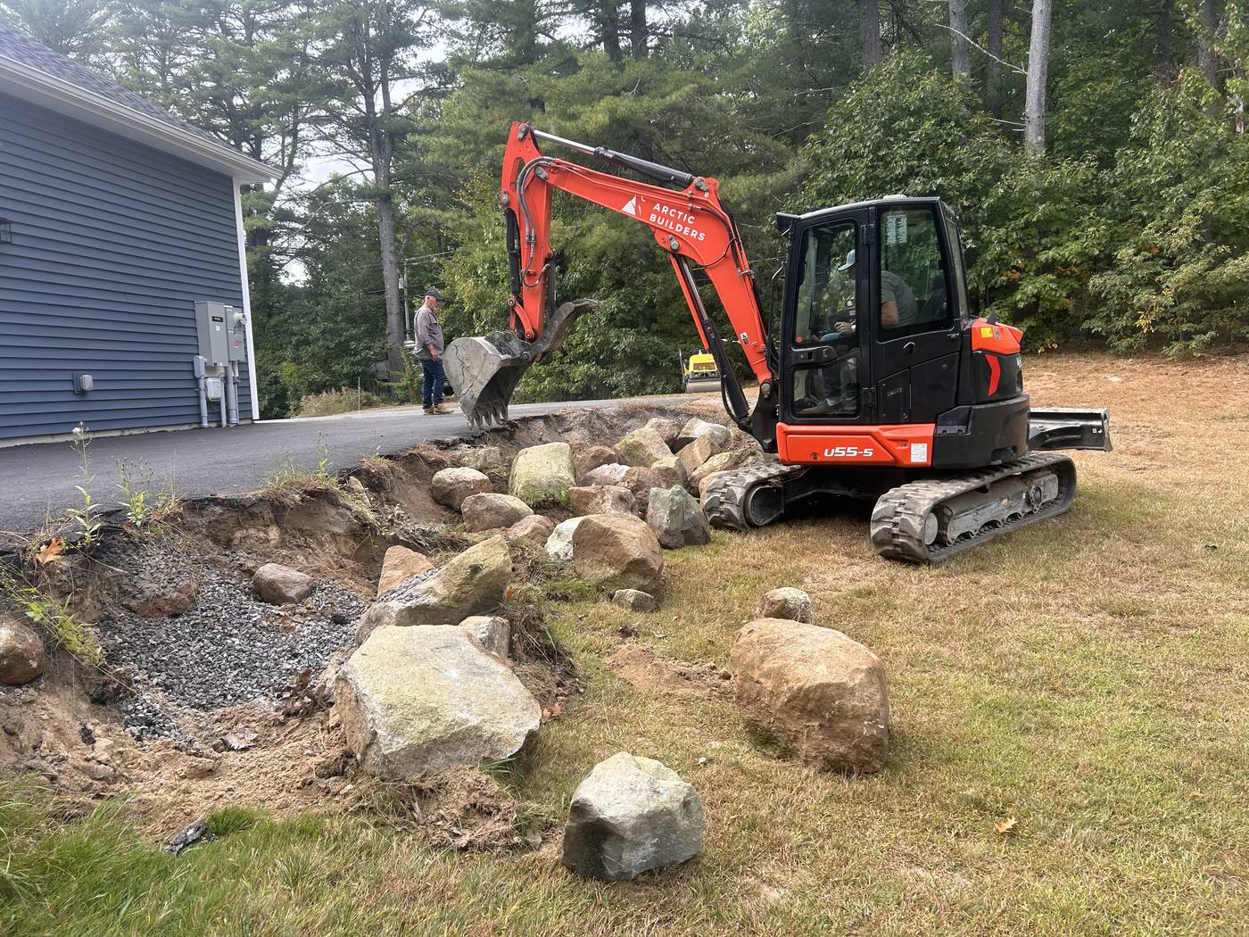 Culvert replacement and drainage work with excavator