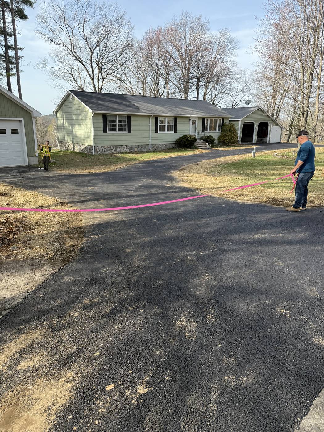 Freshly paved driveway with loamed and seeded edges